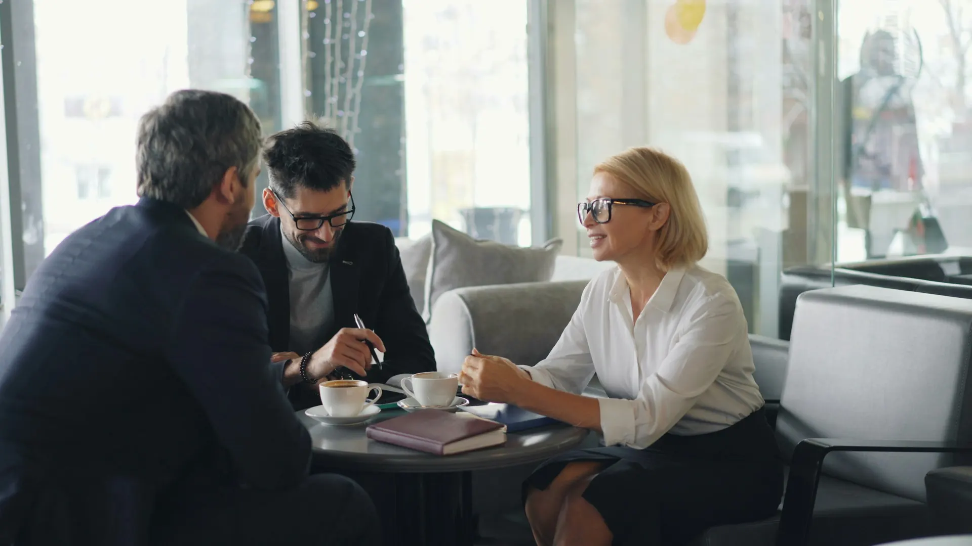 Advisor in a private meeting with clients reviewing documents